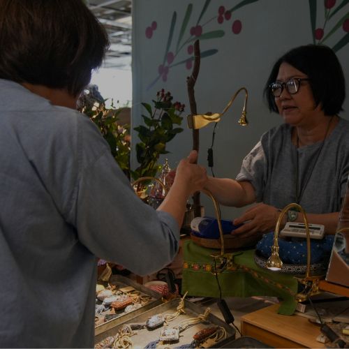 Market visitors browsing stalls